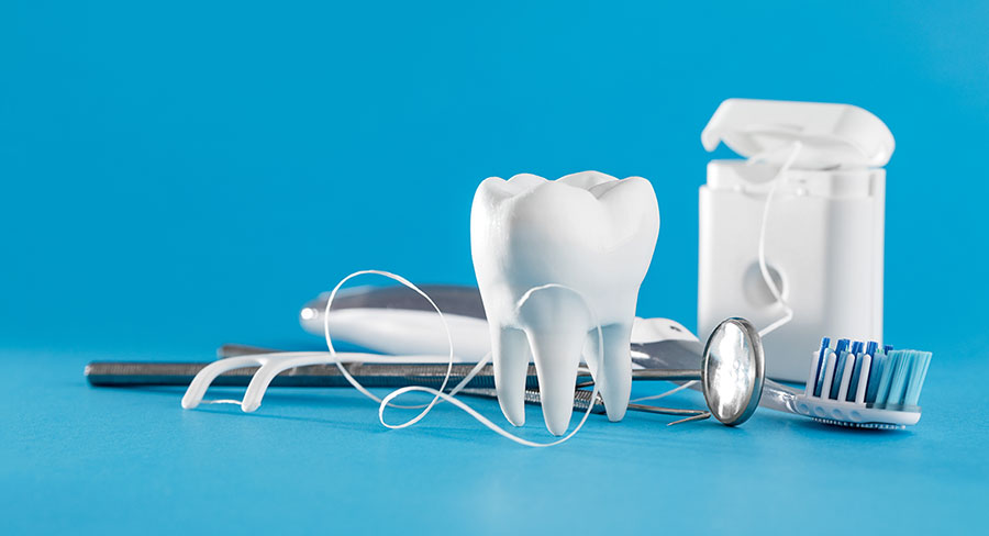 tooth dentist floss and dental tools on blue background